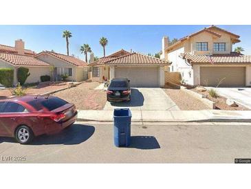 Charming single-story homes featuring desert landscaping and attached garages at 7643 Kalmalii Ave, Las Vegas, NV 89147