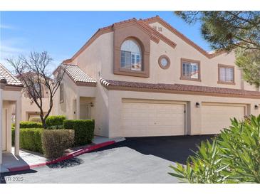 Charming two-story home with a well-maintained front yard and attached two-car garage in a suburban neighborhood at 8301 Boseck Dr # 215, Las Vegas, NV 89145