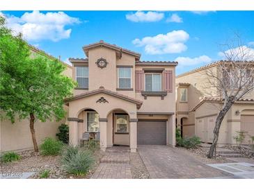 Charming two-story home with a cozy front porch and well-maintained landscaping in a desirable neighborhood at 8349 Spruce Bay Ave, Las Vegas, NV 89178