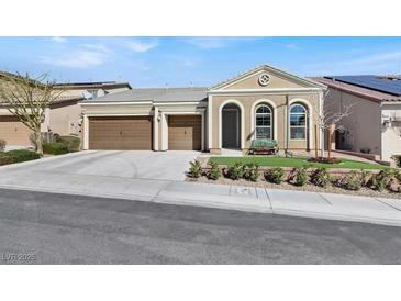 Charming single-story home featuring a three-car garage, arched windows, and a well-maintained front yard at 920 Claystone Ridge Ave, North Las Vegas, NV 89084