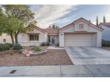 Charming single-story home with stucco exterior, tile roof, and mature landscaping at 9421 Gold Mountain Dr, Las Vegas, NV 89134