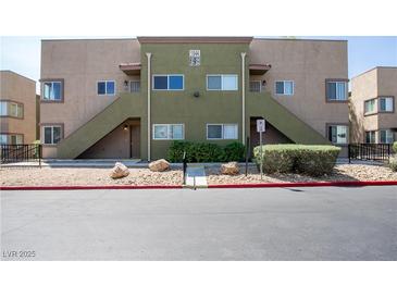 Inviting condo complex with two-tone neutral paint and well maintained desert landscaping at 1844 N Decatur Blvd # 203, Las Vegas, NV 89108