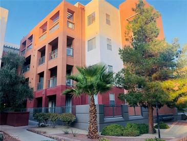 Stylish apartment building with balconies, modern architecture and desert landscaping at 19 E Agate Ave # 406, Las Vegas, NV 89123