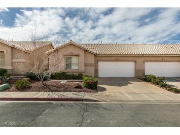 Charming single-story home featuring a two-car garage, desert landscaping, and a tile roof at 205 Crown Imperial St, Henderson, NV 89074