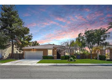 Charming single-story home featuring a two-car garage, manicured lawn, and desert landscaping at 2213 Midvale Ter, Henderson, NV 89074