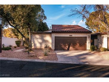 Charming single-story home featuring a tile roof, attached garage, and well-maintained desert landscaping at 2620 San Martin Ct, Las Vegas, NV 89121