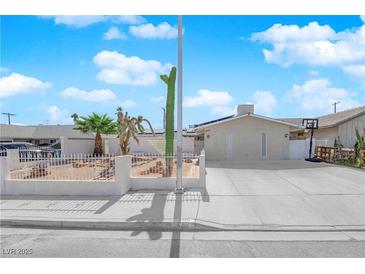 Charming single-story home featuring desert landscaping, a large driveway, and a light-colored exterior at 4301 Fortune Ave, Las Vegas, NV 89107