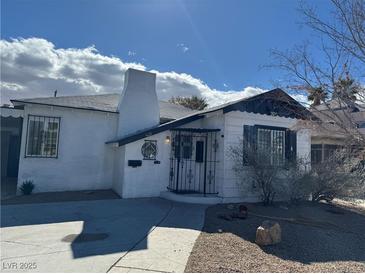 Charming single-story home featuring a unique chimney and decorative ironwork on the entryway at 621 S 9Th St, Las Vegas, NV 89101