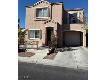 Two-story stucco home features a small balcony and an attached one car garage at 6320 Tier Ave, Las Vegas, NV 89139