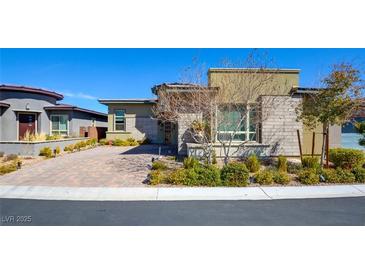 Beautiful single-story home with stone accents, desert landscaping, and a brick-paved driveway at 6722 Desert Crimson St, Las Vegas, NV 89148