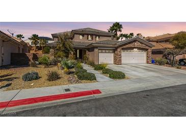 Charming two-story home featuring a well-manicured yard and a spacious three-car garage at 941 Armandito Dr, Las Vegas, NV 89138