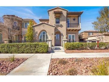 Charming two-story home with a beautiful stucco exterior and a well-maintained front yard at 11354 Merado Peak Dr, Las Vegas, NV 89135