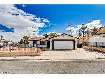 Charming single-story home featuring a spacious two-car garage and well-maintained front yard at 1813 Pluto Dr, Las Vegas, NV 89108