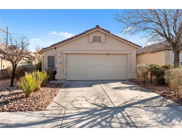 Charming single-story home featuring a well-maintained front yard and a two-car garage, all under a clear blue sky at 2137 Hidden Ranch Ter, Henderson, NV 89052