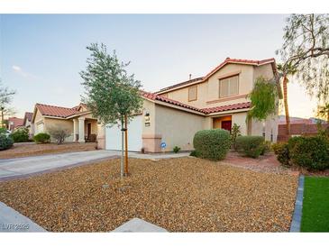 Inviting home with a landscaped front yard, healthy tree and a well-maintained exterior at 3725 Shanagolden St, Las Vegas, NV 89129