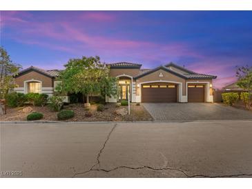 Charming single-story home featuring a well-manicured front yard and a three-car garage at 3914 Jacob Lake Cir, Las Vegas, NV 89118