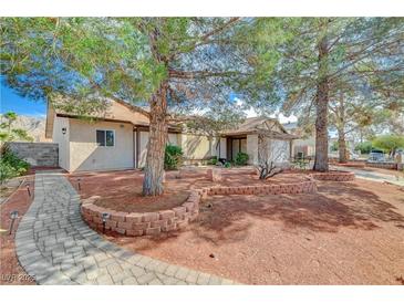 Charming single-story home featuring mature trees, brick accents, and a welcoming walkway at 872 Linn Ln, Las Vegas, NV 89110