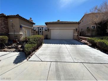 Charming single-Gathering home with a well-maintained desert landscape and a long driveway at 9361 Olympia Falls Ave, Las Vegas, NV 89149