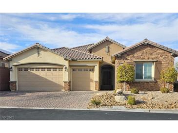 Inviting single-story home with a three-car garage and charming desert landscaping at 10732 Irving Park Ave, Las Vegas, NV 89166