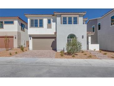 Charming two-story home featuring a two car garage, neutral stucco, and well manicured landscaping at 1320 Crimson Sunbird Ave, North Las Vegas, NV 89084