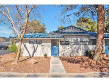 Charming single-story home featuring a blue tiled roof and a well-maintained front yard at 2110 Bavington Dr # C, Las Vegas, NV 89108