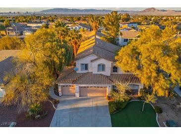 Charming two-story home with a three-car garage and a well-manicured front yard at 2204 Ambermill Ct, Henderson, NV 89052