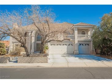 Charming two-story home with tile roof, three-car garage, and manicured landscaping at 2493 Ram Crossing Way, Henderson, NV 89074