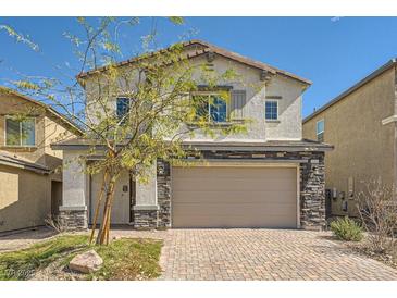 Charming two-story home features a well-maintained front yard and a spacious two-car garage at 3004 Moulin Heights St, Las Vegas, NV 89156