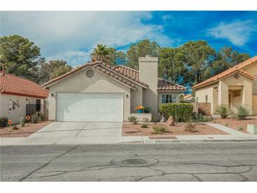 Charming single-story home features a two-car garage, tile roof, and well-maintained landscaping at 3213 Oyster Bay St, Las Vegas, NV 89117