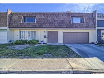 Charming townhome featuring a unique roof, complemented by a well-kept lawn and a welcoming front entrance at 3251 Southridge Ave, Las Vegas, NV 89121