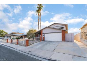 Charming single-Gathering home featuring a two-car garage, brick accents, and a well-maintained front yard at 608 Cragin Park Dr, Las Vegas, NV 89107