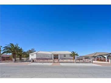 Charming single-story home featuring a gated entry, desert landscaping and a spacious two car garage at 736 N Kiel St, Henderson, NV 89015