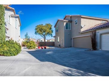 Spacious driveway and well-maintained yard complement this inviting home's exterior at 9932 Twilight Walk Ave, Las Vegas, NV 89149