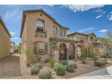 Charming two-story home with a gated front porch and desert landscaping at 1111 Frye Mesa Ave, North Las Vegas, NV 89086