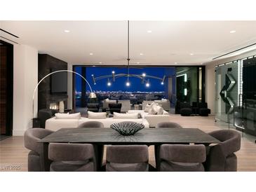 Stunning open-plan living and dining area boasts panoramic city views and elegant modern furnishings at 11660 Summit Club Dr # 204, Las Vegas, NV 89135