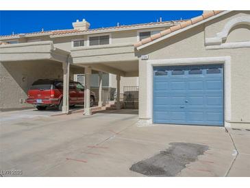 Two-story home features private carport, attached garage, and desert landscaping at 2194 Camel Mesa Dr, Laughlin, NV 89029