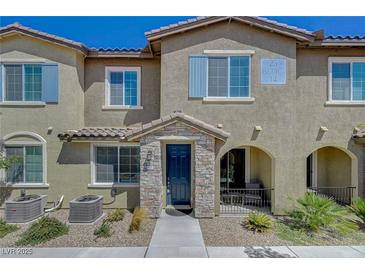 Charming townhome featuring a stone accented entrance and covered porch for relaxing and enjoying the outdoors at 25 Barbara Ln # 67, Las Vegas, NV 89183