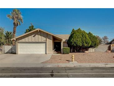 Charming single-story home featuring a well-maintained front yard, mature trees, and an attached two-car garage at 2974 Lindell Rd, Las Vegas, NV 89146