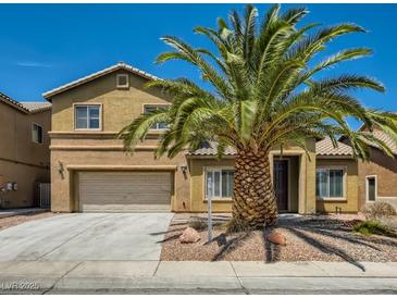 Two-story home featuring a front yard with desert landscaping and a large palm tree at 3516 Bryan Keith Ave, North Las Vegas, NV 89031