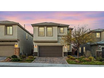 Charming two-story home featuring a two-car garage, neutral stucco, and a well-maintained front yard at 356 Free Fall Ave, North Las Vegas, NV 89084