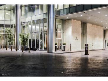 Elegant building entrance with modern architectural design and manicured landscaping at Waldorf Astoria Residences at 3750 Las Vegas Blvd # 2408, Las Vegas, NV 89158