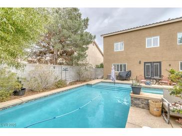 Sparkling pool with patio seating area, perfect for relaxation and entertaining guests at 4446 Scarlet Sea Ave, North Las Vegas, NV 89031