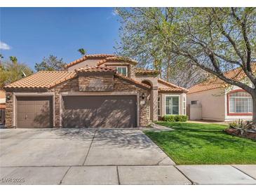 Charming single-story home with a three car garage and a well-manicured lawn at 4516 Whelk Pl, North Las Vegas, NV 89031