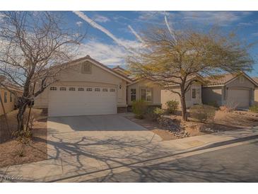 Inviting single-story home with desert landscaping and an attached two-car garage at 5989 Sierra Medina Ave, Las Vegas, NV 89139