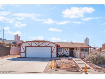 Charming single-story home featuring a two-car garage and desert landscaping at 6731 Fallona Ave, Las Vegas, NV 89156