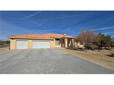 Charming single-story home with a spacious three-car garage and a well-maintained desert landscape at 720 Florida St, Pahrump, NV 89048