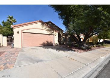 Charming home with a two-car garage and low maintenance landscaping at 7624 Desert Delta Dr, Las Vegas, NV 89128