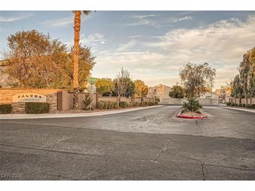 Paloma at Skystone Springs street view with lush trees and a clear, sunny sky overhead at 7728 White Flower Ct, Las Vegas, NV 89131