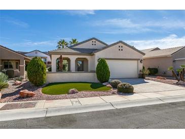 Charming single-story home with manicured lawn, neutral paint, and two car garage at 1811 Tiger Creek Ave, Henderson, NV 89012