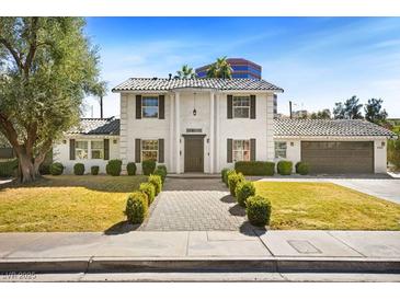 Charming two-story home with a meticulously landscaped yard and a well-maintained walkway at 2301 W El Camino Ave, Las Vegas, NV 89102